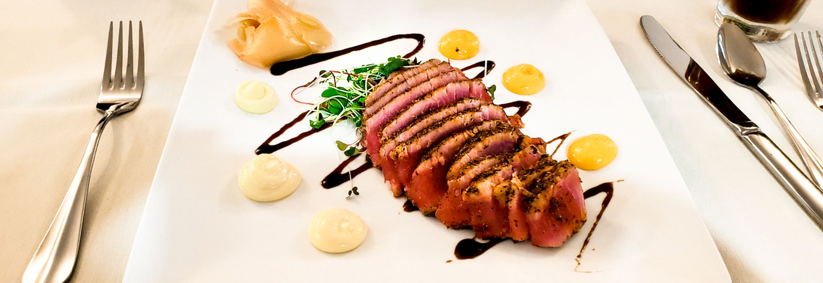 professionally prepared seared tuna with multiple glazes